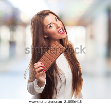 portrait of a beautiful young woman holding a chocolate tablet