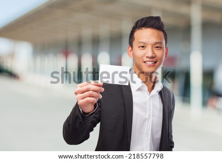portrait of an asian man holding a white card