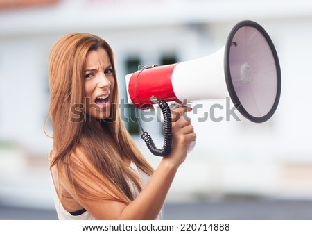 portrait of a young woman shouting with a megaphone