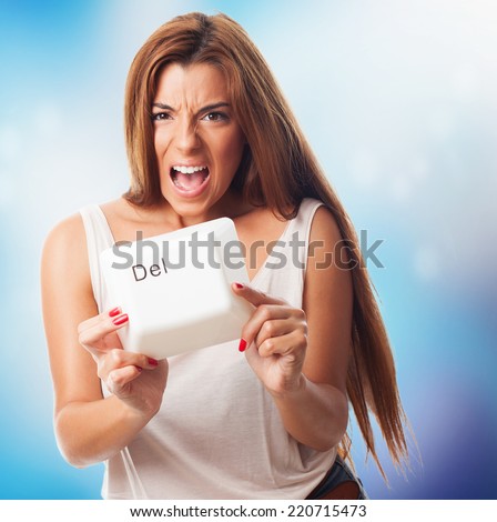 A young woman holding a delete key of a keyboard