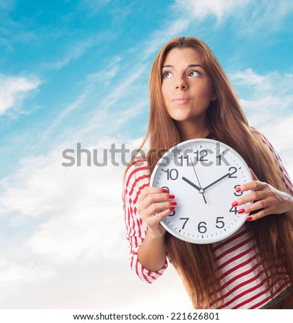 portrait of a young woman holding a clock thinking about something