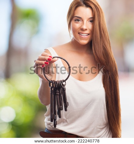 portrait of a young woman holding a vintage bunch of keys