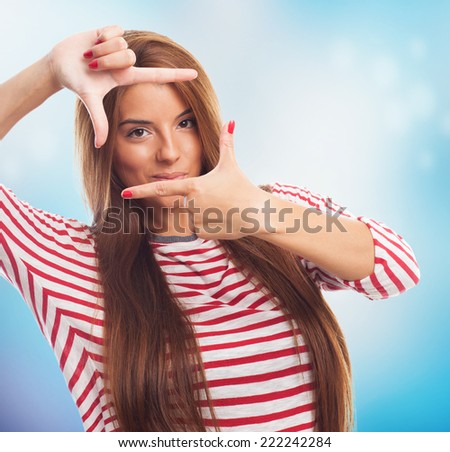 portrait of a young woman doing a frame gesture