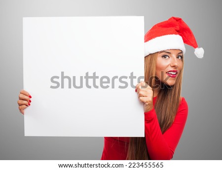 portrait of a beautiful young woman at Christmas holding a white banner