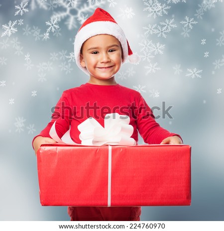 portrait of a little boy holding a big gift