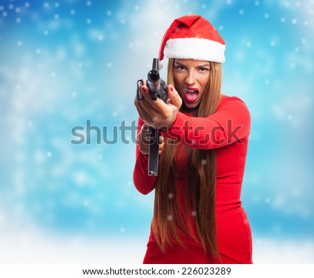 portrait of a beautiful young woman pointing a gun at Christmas