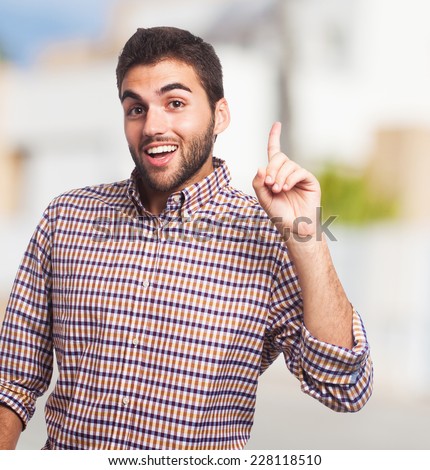 portrait of a handsome man pointing up with finger