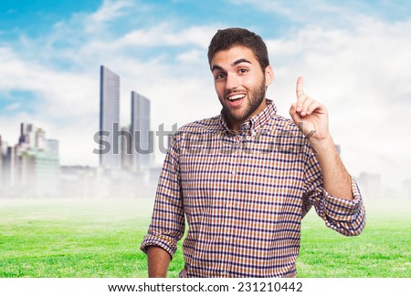 portrait of a handsome man pointing up with finger