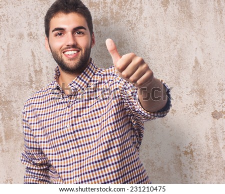 portrait of a handsome young man with thumb up