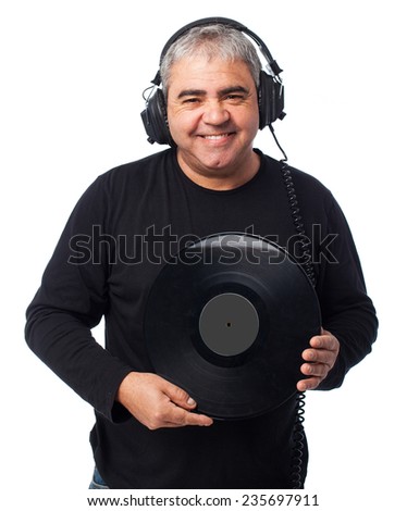 portrait of a mature man listening to music and holding a vinyl