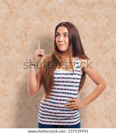 portrait of a young woman pointing up with finger