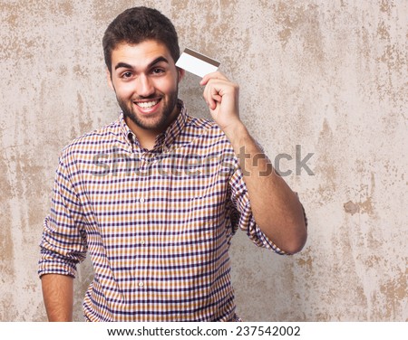 portrait of a handsome young man holding a credit card