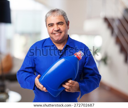 portrait of a mechanic holding an oil bottle