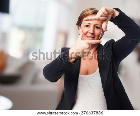 portrait of a mature business woman doing a frame gesture