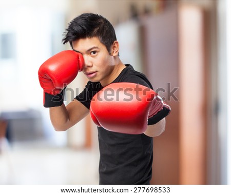 happy chinese sport man with boxing gloves
