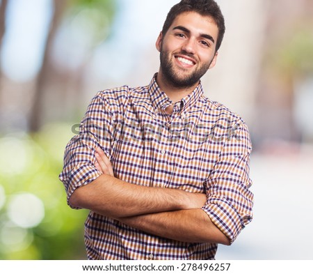 Portrait of a handsome young man with crossed arms