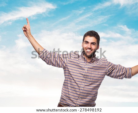portrait of a young man pointing up with both hands