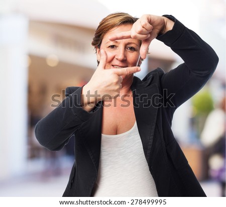 portrait of a mature business woman doing a frame gesture
