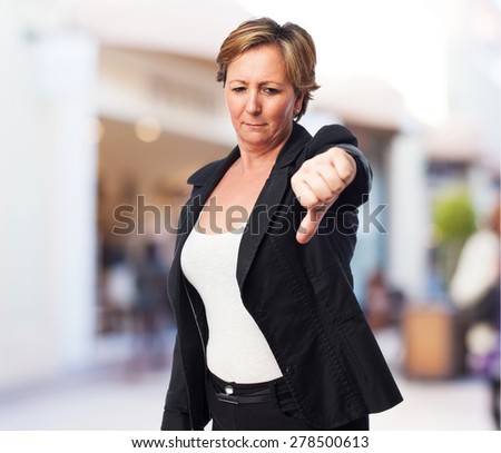 portrait of a mature business woman with thumb down