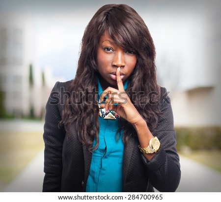 happy black-woman doing silence sign