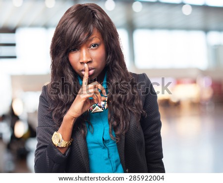 happy black-woman doing silence sign