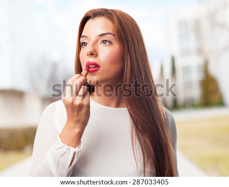 elegant woman using a lipstick