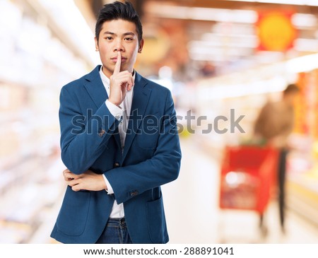 chinese man silence gesture