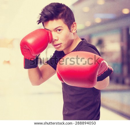 happy chinese sport man with boxing gloves