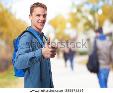 student man with back-pack doing okay sign