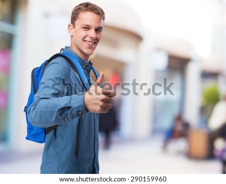 student man with back-pack doing okay sign