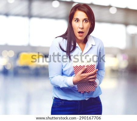 scared young woman with popcorn