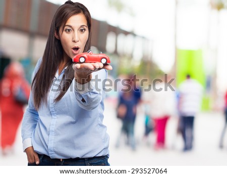 surprised young woman with red car