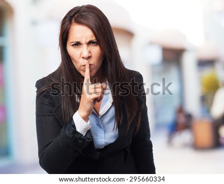 cool business-woman doing silence sign