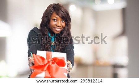 happy black woman holding a gift