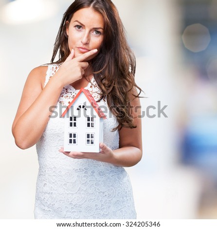 woman holding a house and thinking about something