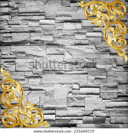 Pattern of wood carve flower on stone wall background ,Pattern of wood carve flower frame on sandstone Brick Wall Surfaced background