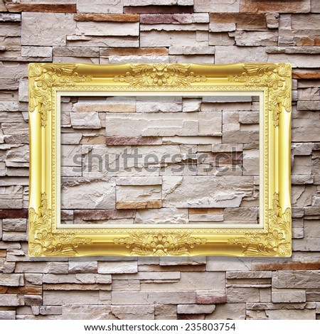 Antique frame on stone wall background ,gold picture frame on sandstone Brick Wall Surfaced background