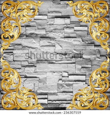 Pattern of wood carve flower on stone wall background ,Pattern of wood carve flower frame on sandstone Brick Wall Surfaced background