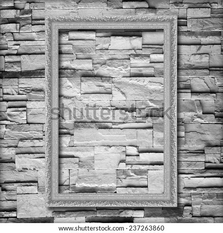 Antique silver frame on stone wall background ,silver picture frame on sandstone brick wall Surfaced background
