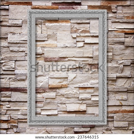 Antique silver frame on stone wall background ,silver picture frame on sandstone brick wall Surfaced background