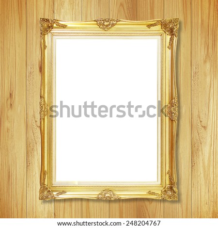 Antique gold frame on wooden wall ;. Empty picture frame on white wooden wall.