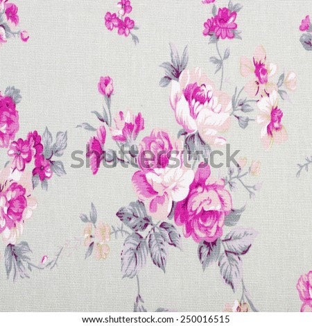 Rose vintage from fabric on wooden background.