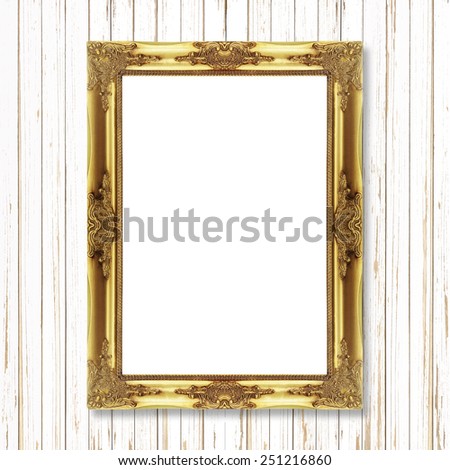 Antique gold frame on white wooden wall ;. Empty picture frame on white wooden wall.