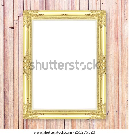 Antique gold frame on wooden wall ;. Empty picture frame on white wooden wall.