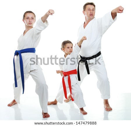 Family sportsmen two sisters with her father in a kimono beat punch arm