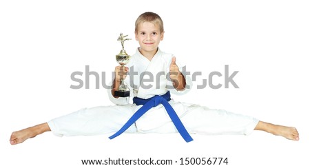 Boy in a kimono sits on a twine with the award at the hands of isolated