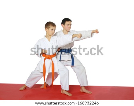 Strong punch hand in the performance of athletes with a blue belt and orange belt
