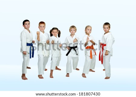In kimono six athletes perform karate techniques