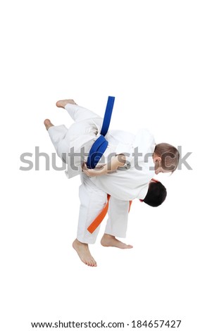 Boy with orange belt is doing throw a boy with blue belt