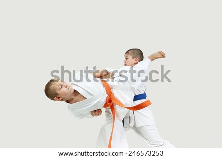 Boys in karategi are doing paired exercises karate